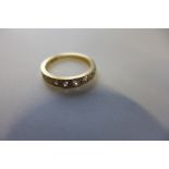 An 18ct gold and diamond half eternity ring, set with nine old European cut diamonds, the largest