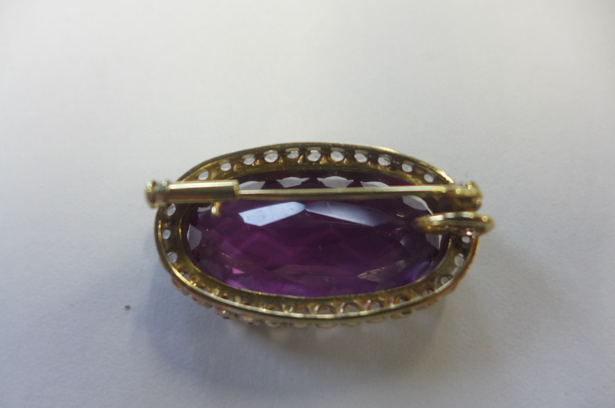 A 9ct gold amethyst and white stone brooch, not hallmarked but stamped 9ct to pin and tests as - Image 2 of 2