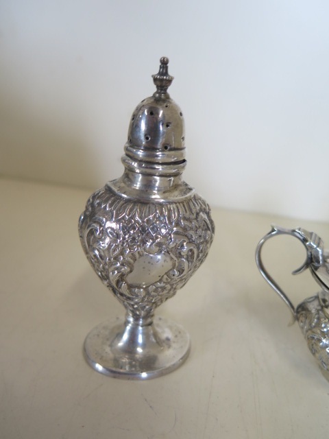 A silver embossed three piece cruet set, hallmarked Birmingham 1909 - by Joseph Glostor Ltd, - Image 2 of 6