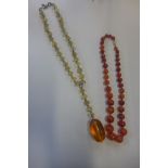 A vintage string of Carnelian beads and a glass bead and faux amber necklace, good condition