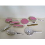 A silver and enamel five piece dressing table set, hallmarked Birmingham, chip to one piece, and a