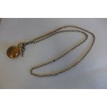 A gold plated watch chain with a gold plated sovereign case, chain approx 80cm long, general wear to