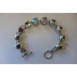 A Taxco 980 silver bracelet made up of individual triangular links, set with various hard stones,