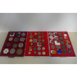 A collection of assorted medallions and medals in three show cases dating from the early 19th
