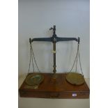 A 7lb brass beam scale by De Grave and Co, London, in fitted oak case