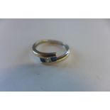 An 18ct white gold sapphire and diamond ring, marked 750, diamonds 0.10ct, size L - approx 1.8