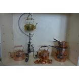 A collection of copper ware, three lidded pans, two kettles, pot and a brass kettle on stand