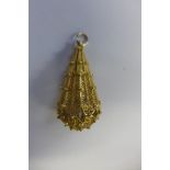 A large yellow metal drop shape filigree pendant, no hallmarks but tested to 9ct gold or above,