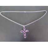 A large silver and amethyst cross set with five oval and one round amethyst stones, oval stones