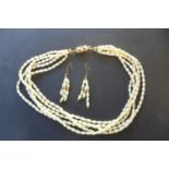 A Baroque pearl five string necklace with 18ct gold clasp, together with a matching pair of three