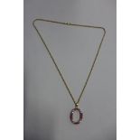 An 18ct gold ruby and diamond oval pendant 25x20mm, marked 18K, on an 18ct yellow gold chain, 50cm