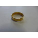 A hallmarked 22ct yellow gold band ring, size R, approx 3.3 grams, general usage marks