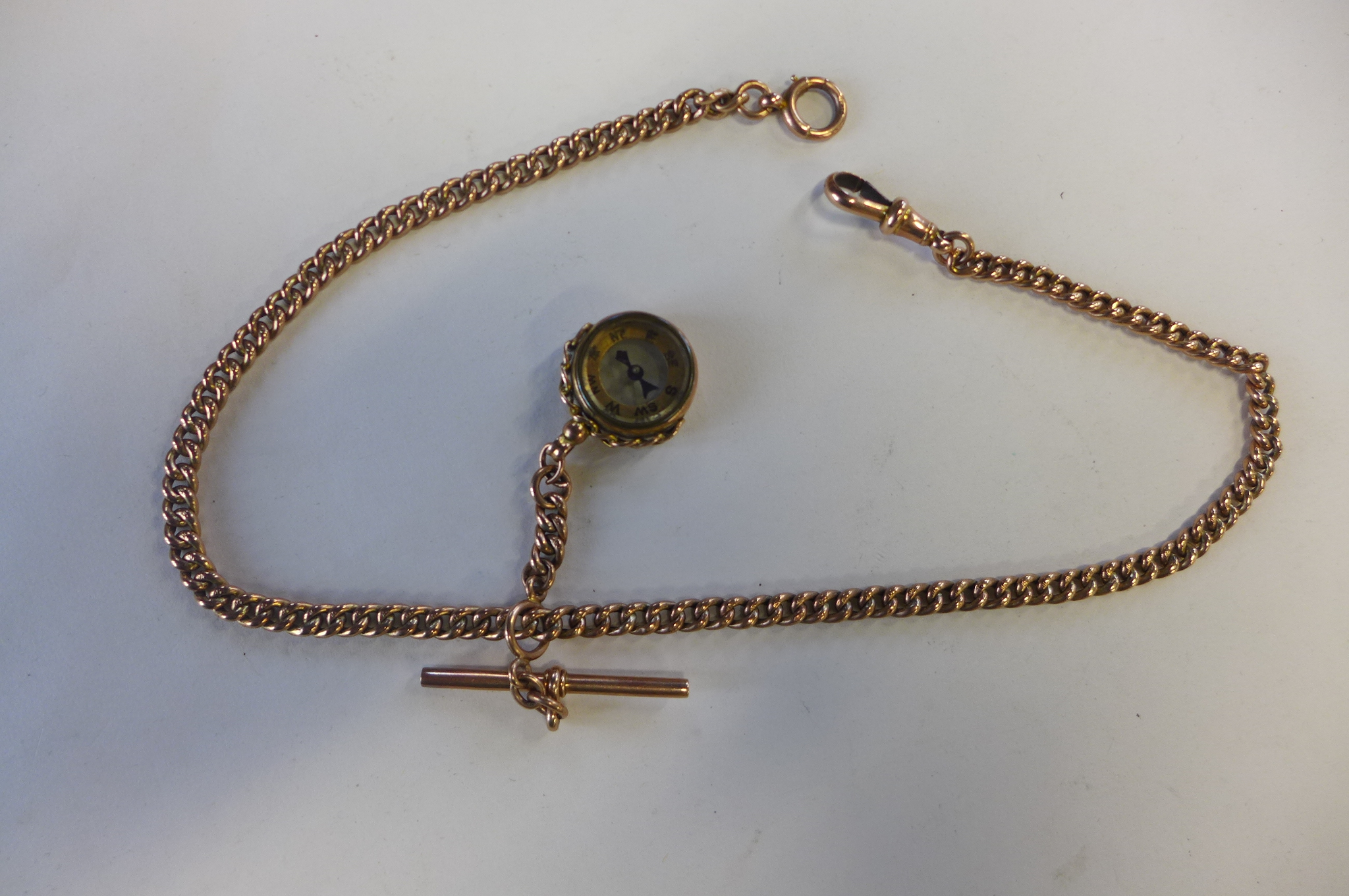 A 9ct rose gold double Albert watch chain, with running link T-bar, and 9ct compass fob, circular