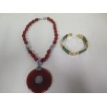 A silver and agate necklace, the circular pendant diameter 56mm, necklace length 48cm, and a gold