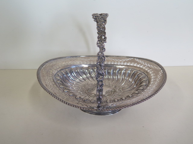 An embossed silver basket with pierced border, Birmingham 1895/96 approx 21.4 toy oz, 24cm tall with