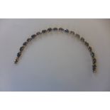 A 14ct gold line bracelet set with oval mystic quartz stones, marked 14K, 18cm long, approx 8.2