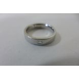 A platinum and diamond ring, size L, approx 7.9 grams, some marks consistent with usage