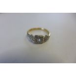 An 18ct gold platinum and diamond solitaire Art Deco style ring, the diamond measuring 0.05cts, or 5