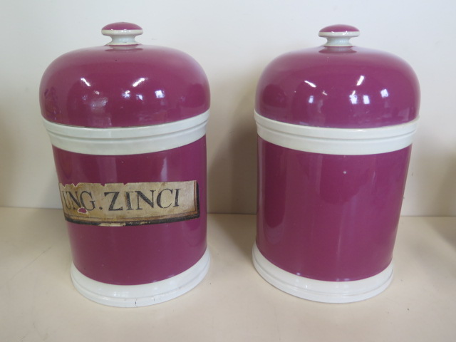 A pair of stoneware lidded chemist bottles, one with paper label UNG.ZINC1 - 25cm tall, 15cm