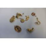 Nine 18ct gold charms, none carry British hallmarks, some stamped 750, all tested to 18ct or