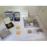 A collection of coins and medallions to include New Zealand proof set with silver Dollar, Apollo