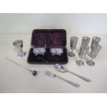 Five silver cased liqueur glasses, a silver egg cup, a silver fork and spoon and two silver salts,