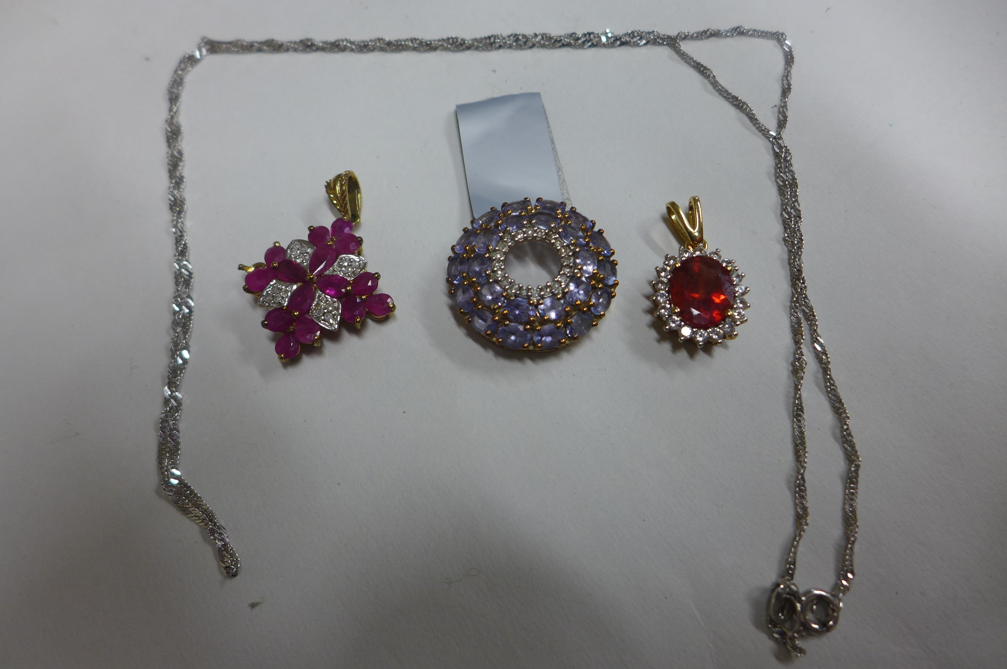 Three 9ct gold pendants and a 9ct white gold chain, total weight approx 10.5 grams, all unworn