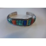 A silver stone set bangle, signed by Navajo artist Jim Bedah