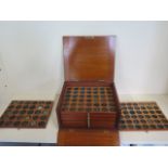 A mahogany coin case with twelve drawers, containing approx 300 coins tokens and medallions