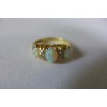 An 18ct gold opal and diamond ring, size J, approx 3.4 grams, opals bright and lively one opal has a