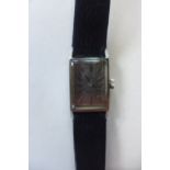 A ladies Omega manual wind wristwatch, on a leather strap, 17mm wide, including winder, generally