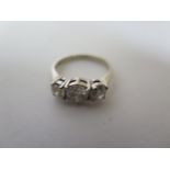 A three stone diamond trilogy ring set in 18ct white gold, approx 1.75ct total, size M, marked 18K