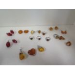 A collection of amber, white metal and silver jewellery including rings, pendants and earrings,