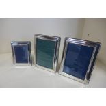 Three silver photo frames, largest 16x12cm, some marks but generally good
