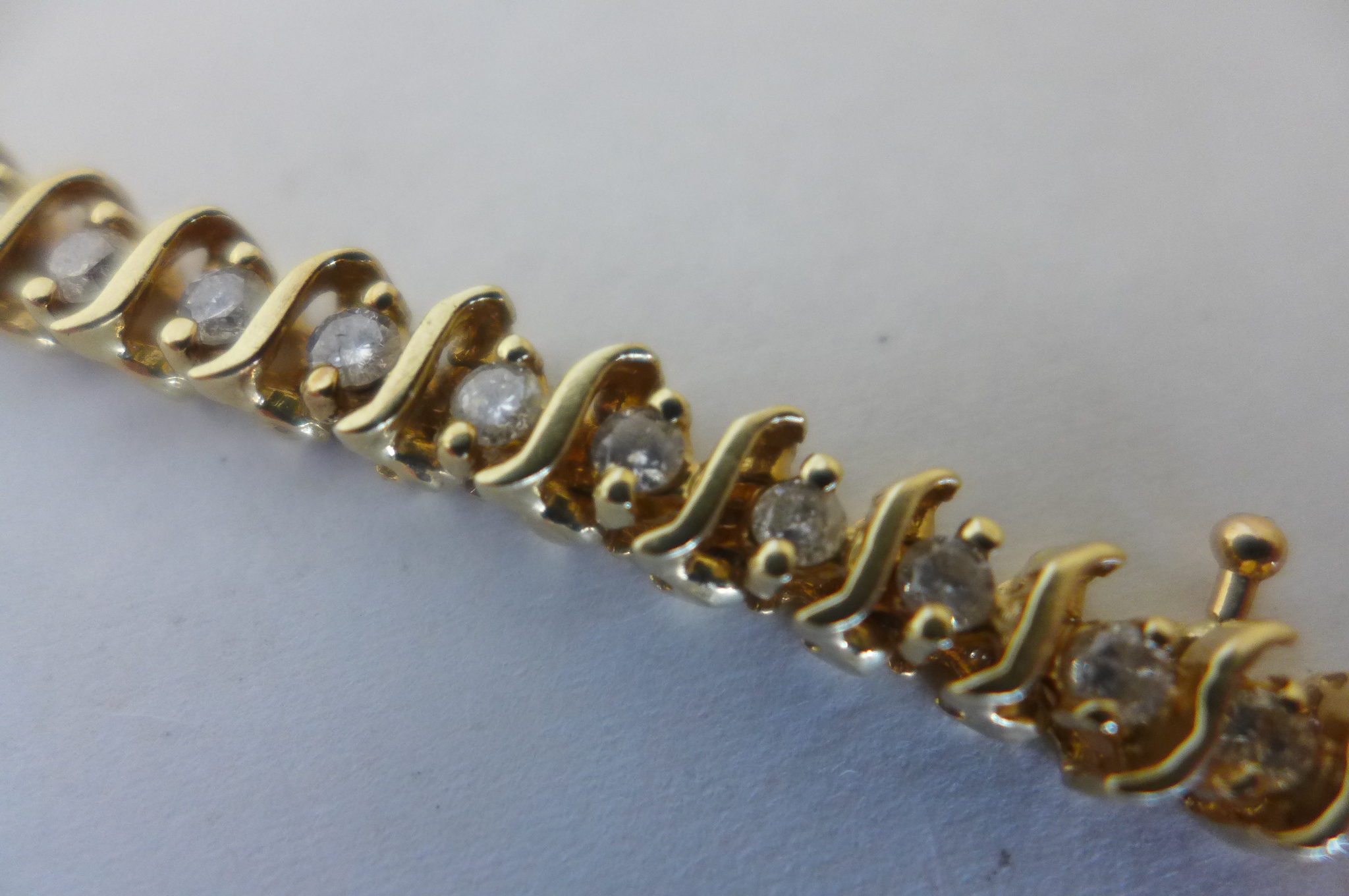 A yellow gold and diamond tennis bracelet, the gold tested to 9ct but the bracelet is not - Image 2 of 3