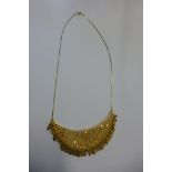 An 18ct gold filigree fringed crescent shape necklace, stamped Iranzar 750 - tested as 18ct,