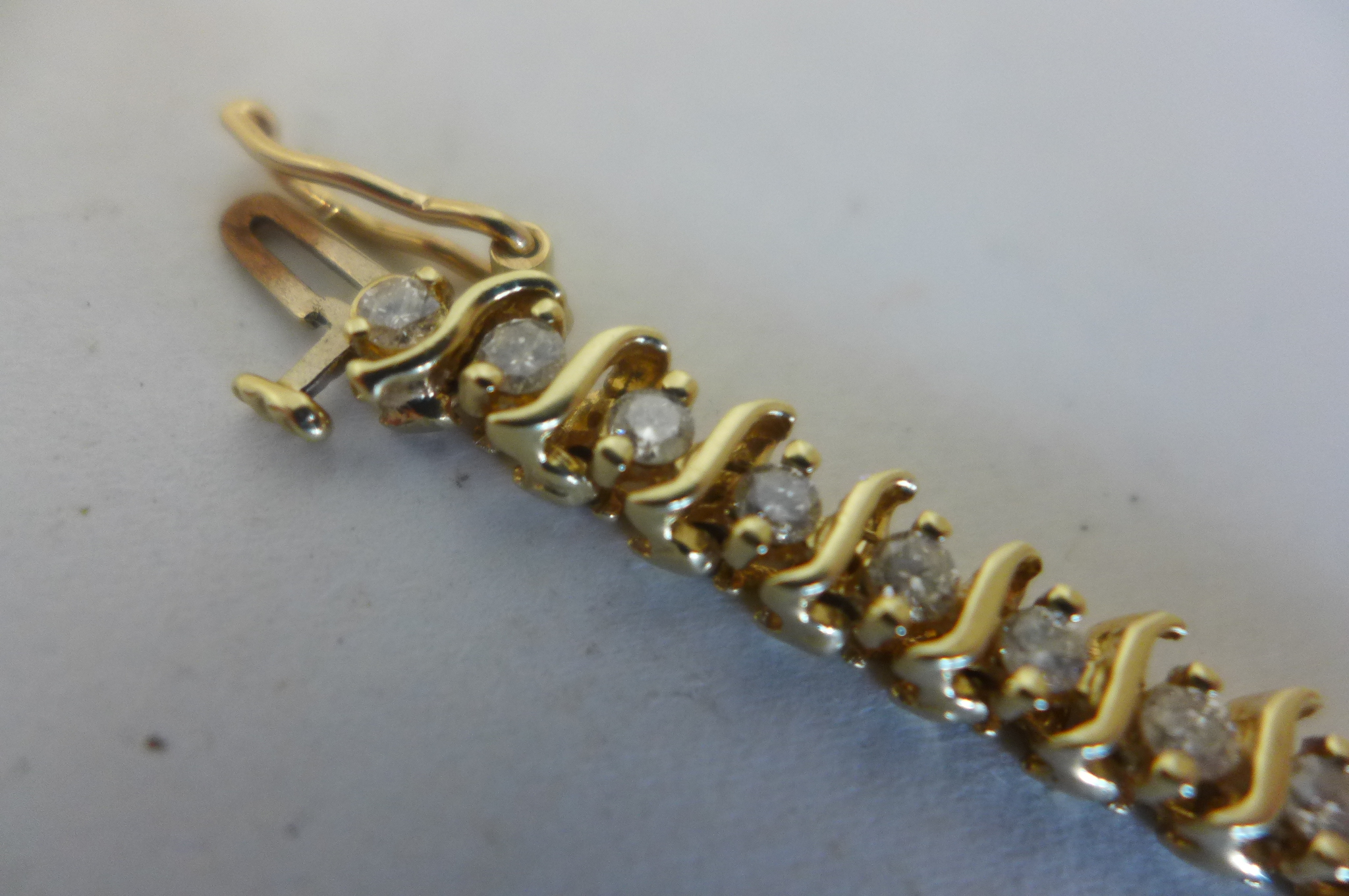 A yellow gold and diamond tennis bracelet, the gold tested to 9ct but the bracelet is not - Image 3 of 3