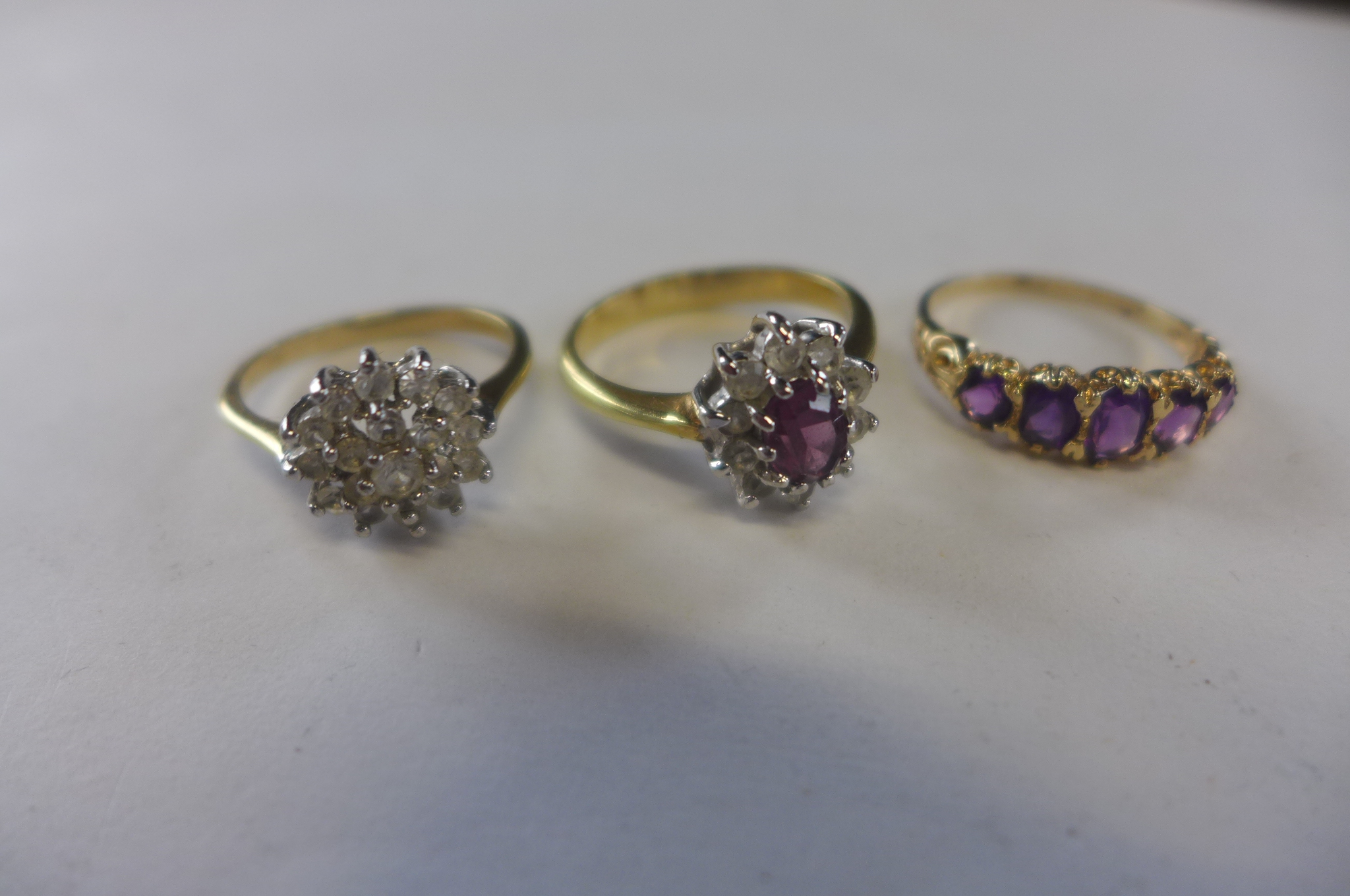 A hallmarked 9ct gold ring, approx 2.4 grams, and two unmarked gilt rings, approx 5.3 grams