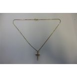 An 18ct gold and diamond cross on 18ct gold chain, stamped 750 and tested to 18ct or above, cross