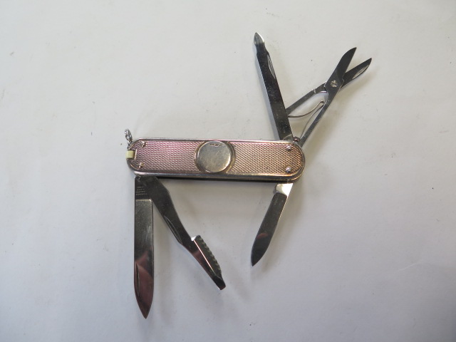 A silver Victorinox penknife, two blades, scissors and two other attachments, generally good, some