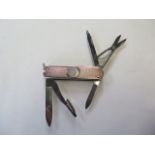 A silver Victorinox penknife, two blades, scissors and two other attachments, generally good, some