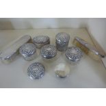 A collection of four silver top bottles, two silver pots, a silver bottle top and two silver back