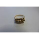 An 18ct diamond ring, stamped 750 and tested as 18ct, set with three rows of small diamonds, total