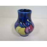 A Moorcroft wisteria small vase, 9cm tall, some crazing - internal hairline crack and minute rim..