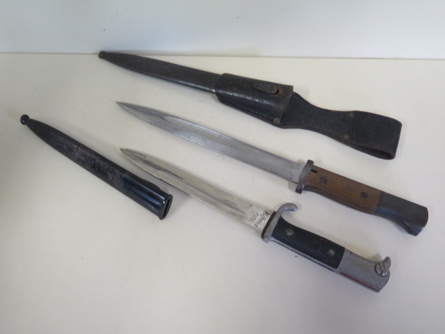 A German Rudolf Buchel bayonet and scabbard, engraved Ph Amend 1939, and another bayonet with wooden