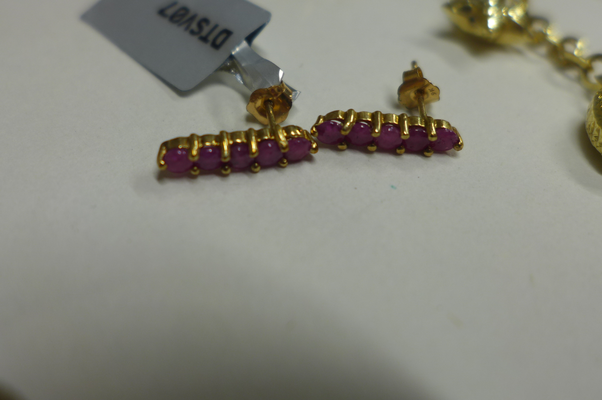 A 9ct yellow gold pendant, a pair of 9ct gold ruby earrings and a 9ct charm bracelet, total weight - Image 2 of 3