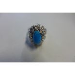 An 18ct white gold and turquoise ring, the shank stamped 750 but tested as 9ct with 18ct wash, the