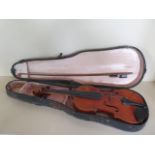 A violin with a two piece 13 1/4 inch back, and Mockba label dated 65, with an un-named bow, and