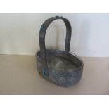 An Arts and Crafts style metal basket with glass liner, 20cm tall, generally good, missing a