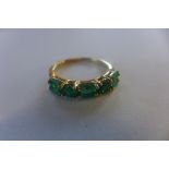 A 9ct ring set with baguette and round cut emeralds, size O, approx 2.4 grams, marked 375, overall